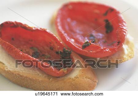 Tomato on slices of bread garnished with herb View Large Photo Image Stock Image - Tomato on slices of bread garnished with herb. Fotosearch