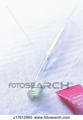 Stock Photography - Toothbrush and toothpaste on towel. Fotosearch