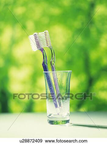 Stock Photo - Toothbrushes in glass. Fotosearch