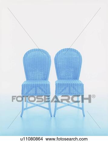 Picture - Two blue wicker chairs, white background. Fotosearch
