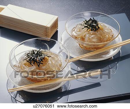 Stock Image - Two cups of Japanese gelatin noodles, black background. Fotosearch