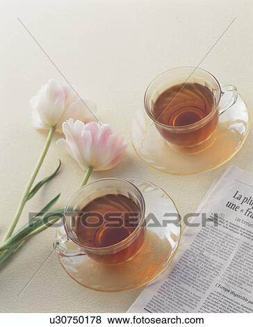 Two cups of tea with pink flowers View Large Photo Image Stock Photo - Two cups of tea with pink flowers. Fotosearch