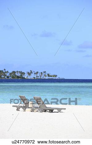 Stock Image - Two deck chairs at the beach, Maldive Islands. Fotosearch