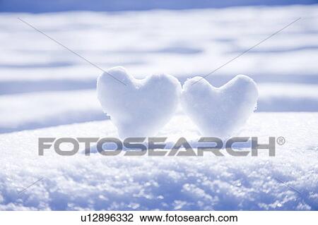 Stock Image - Two Lovehearts made from Snow. Fotosearch