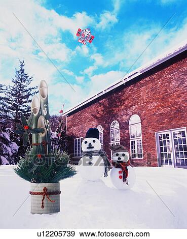 Two snowmen flying a kite in the snow at Christmas time View Large Photo Image Stock Photo - Two snowmen flying a kite in the snow at Christmas time. Fotosearch