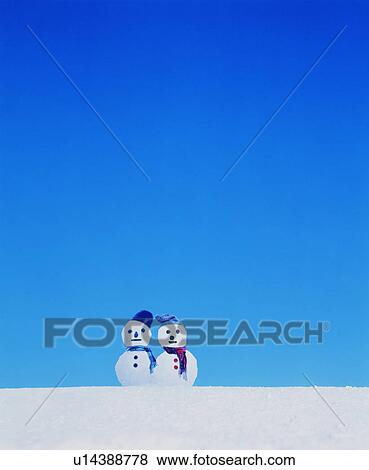 Stock Photo - Two snowmen in the snow. Fotosearch