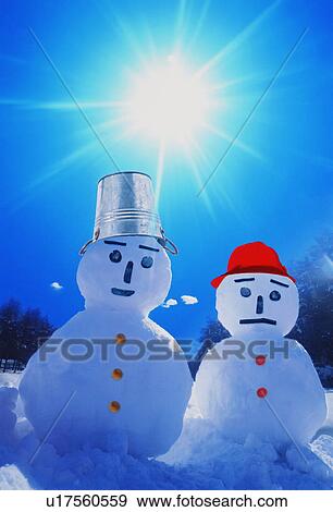 Two snowmen in the snow View Large Photo Image Stock Photo - Two snowmen in the snow. Fotosearch