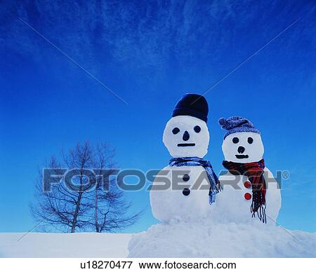 Stock Photo - Two snowmen in the snow. Fotosearch
