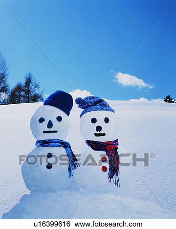 Stock Photograph - Two snowmen in the snow. Fotosearch