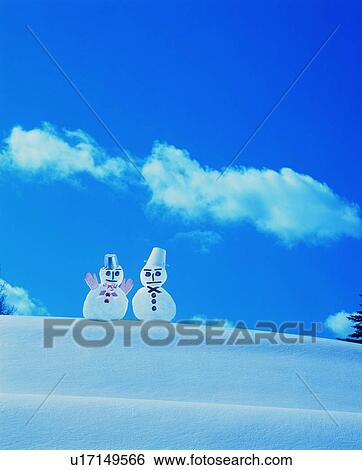 Stock Photograph - Two snowmen in the snow. Fotosearch