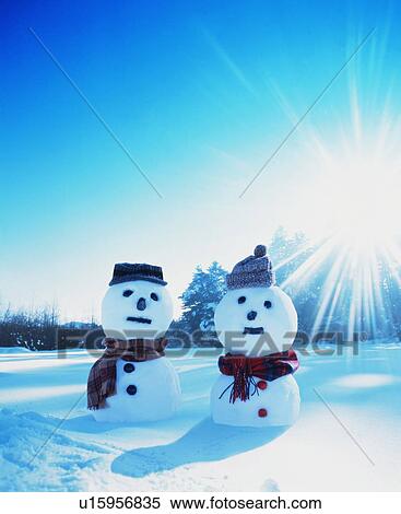 Two snowmen in the snow View Large Photo Image Stock Photography - Two snowmen in the snow. Fotosearch