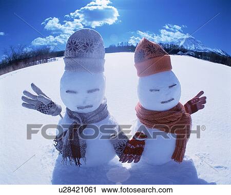 Stock Image - Two snowmen in the sun. Fotosearch