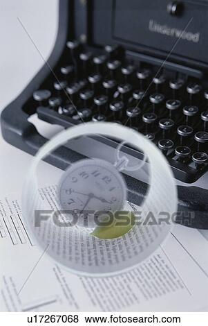 Stock Photo - Typewriter with objects embedded in sphere - digital composite. Fotosearch