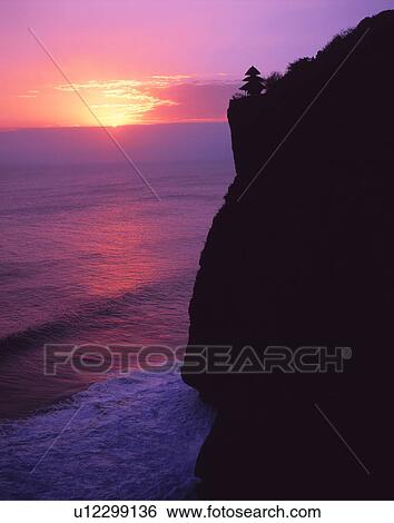 Uluwatu Temple at sunset, Bali, Indonesia View Large Photo Image Stock Photograph - Uluwatu Temple at sunset, Bali, Indonesia. Fotosearch