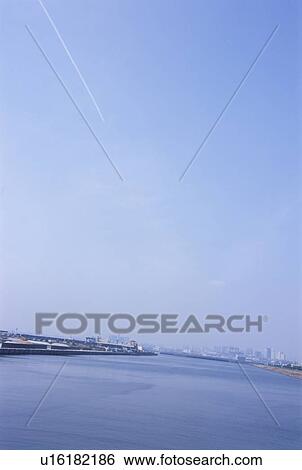 Vapor trail over harbor. Koto-ku, Tokyo, Japan View Large Photo Image Stock Photograph - Vapor trail over harbor. Koto-ku, Tokyo, Japan. Fotosearch