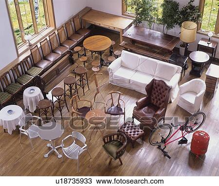 Stock Image - Variety of chairs and bicycle. Fotosearch
