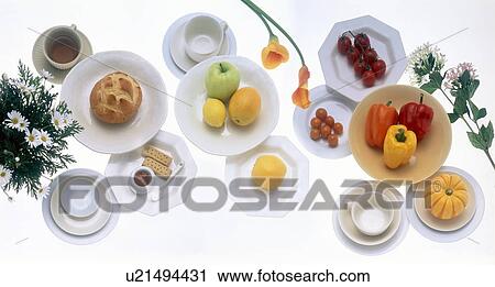 Stock Image - Variety of food dishes with tea. Fotosearch