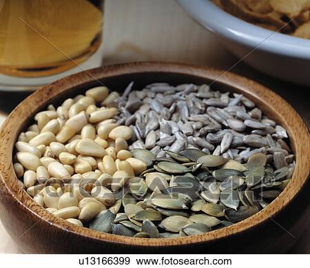Variety of seeds in a wooden bowl View Large Photo Image Stock Photo - Variety of seeds in a wooden bowl. Fotosearch