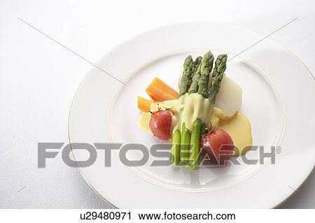 Stock Image - Variety of vegetables with hollandaise sauce. Fotosearch