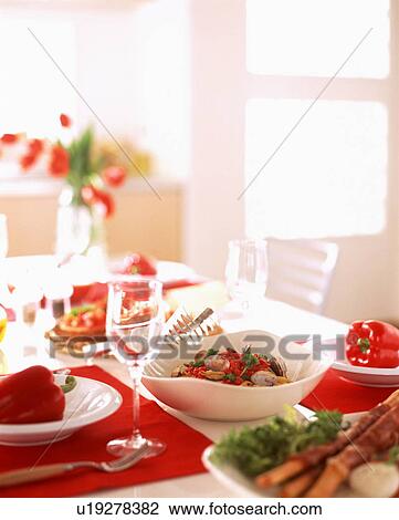 Stock Image - Various dishes on table with wineglass. Fotosearch