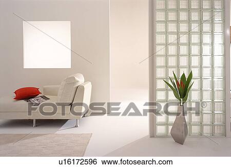 Stock Photograph - Vase of flowers and sofa in modern room. Fotosearch