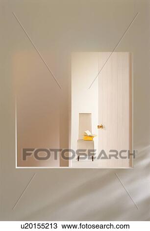 Stock Image - View of room with chair through window. Fotosearch