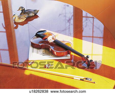 Violin on a polished table with model ducks View Large Photo Image Stock Photo - Violin on a polished table with model ducks. Fotosearch