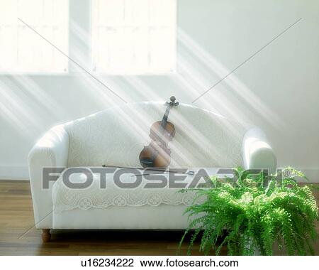 Stock Image - Violin on sofa in living room, computer graphic. Fotosearch