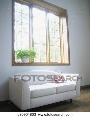 Stock Image - Violin on sofa near window. Fotosearch