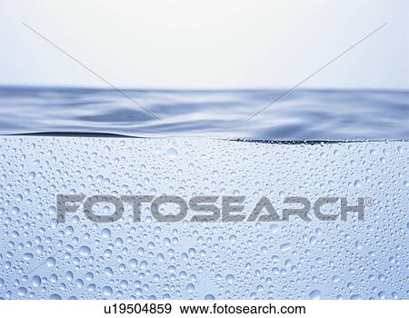 Stock Photo - Water and water drops, close up, white background. Fotosearch