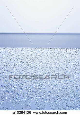 Stock Photograph - Water and water drops, close up, white background. Fotosearch