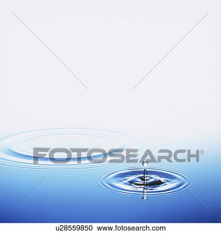 Stock Image - Water drop making ripple, copy space. Fotosearch