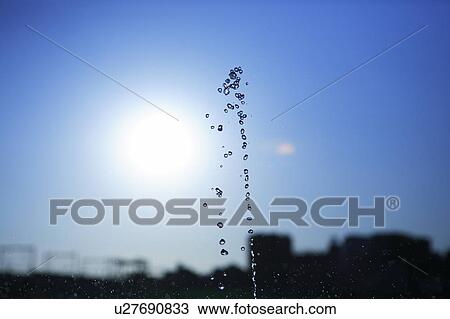 Stock Image - Water drops against blue sky. Fotosearch