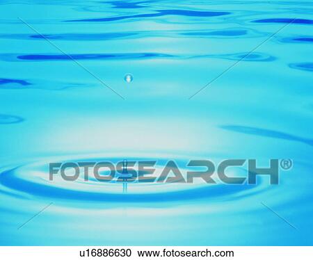 Stock Image - Waterdrop and ripples on water surface. Fotosearch
