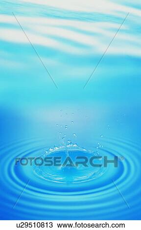 Stock Image - Waterdrop and ripples on water surface. Fotosearch