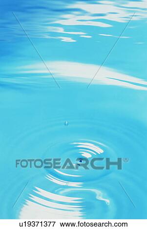 Waterdrop and ripples on water surface View Large Photo Image Stock Photo - Waterdrop and ripples on water surface. Fotosearch