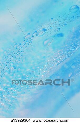 Picture - Waterdrops on blue surface. Fotosearch