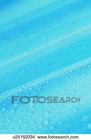 Picture - Waterdrops on blue surface. Fotosearch