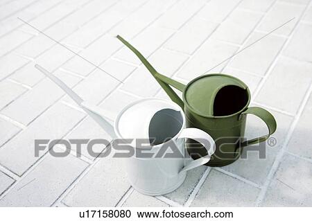 Watering cans side by side View Large Photo Image Stock Image - Watering cans side by side. Fotosearch