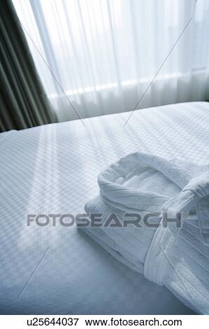 White bathrobe on bed View Large Photo Image Stock Photo - White bathrobe on bed. Fotosearch