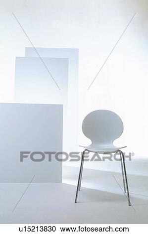 Stock Image - White chair in white room. Fotosearch