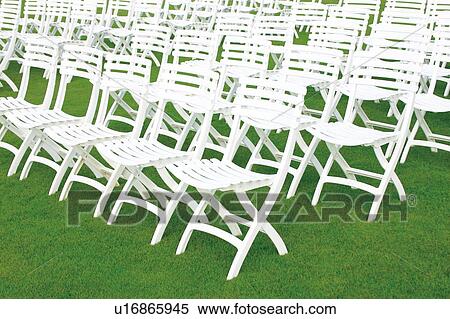 White lawn chairs in rows View Large Photo Image Stock Photography - White lawn chairs in rows. Fotosearch
