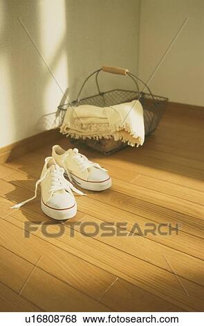 White sneakers and metal basket on wooden floor View Large Photo Image Stock Photo - White sneakers and metal basket on wooden floor. Fotosearch