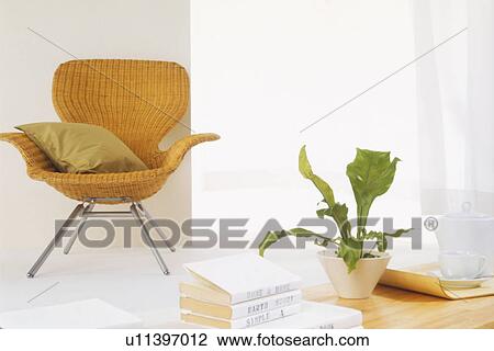 Wicker chair in room with coffee table View Large Photo Image Stock Image - Wicker chair in room with coffee table. Fotosearch