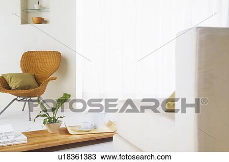 Stock Image - Wicker chair with coffee table and sofa. Fotosearch