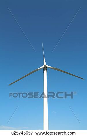 Stock Photo - Wind turbine against sky, blue background. Fotosearch