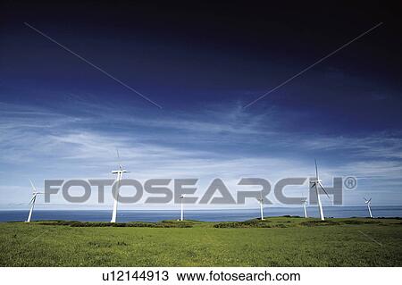 Stock Image - Wind turbines by the sea. Hokkaido, Japan. Fotosearch