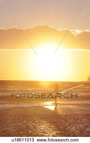 Stock Image - Windsurfer checking out the waves. Shonan, Kamakura, Kanagawa Prefecture, Japan. Fotosearch