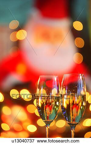 Stock Photo - Wineglasses in front of Christmas decorations. Fotosearch