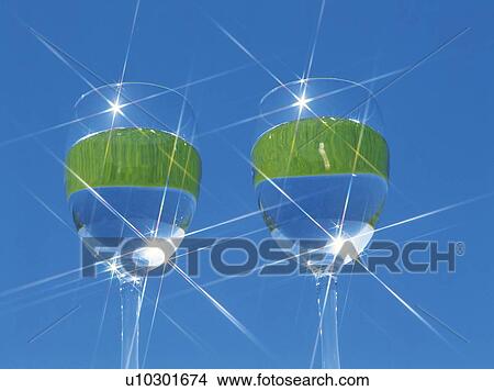 Picture - Wineglasses of water reflecting the sun, blue sky and grass. Fotosearch